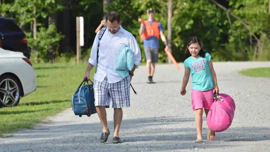 Father Dropping Child Of At A Christian Overnight Summer Camp