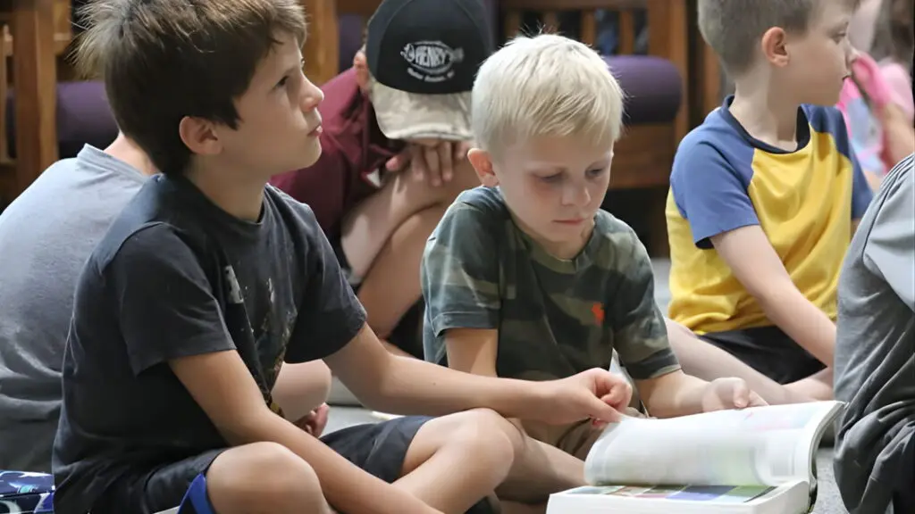 Campers Participating In Bible Reading At Christian Summer Camp