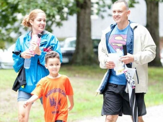 A Father And Two Children Enjoying A Family Camping Trip With A Bit Of Sunshine, While Prepared For Rain At Wcrc.