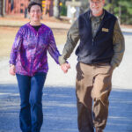 A Couple Walking On A Sunny Day At Williamsburg Christian Retreat Center In Virginia.