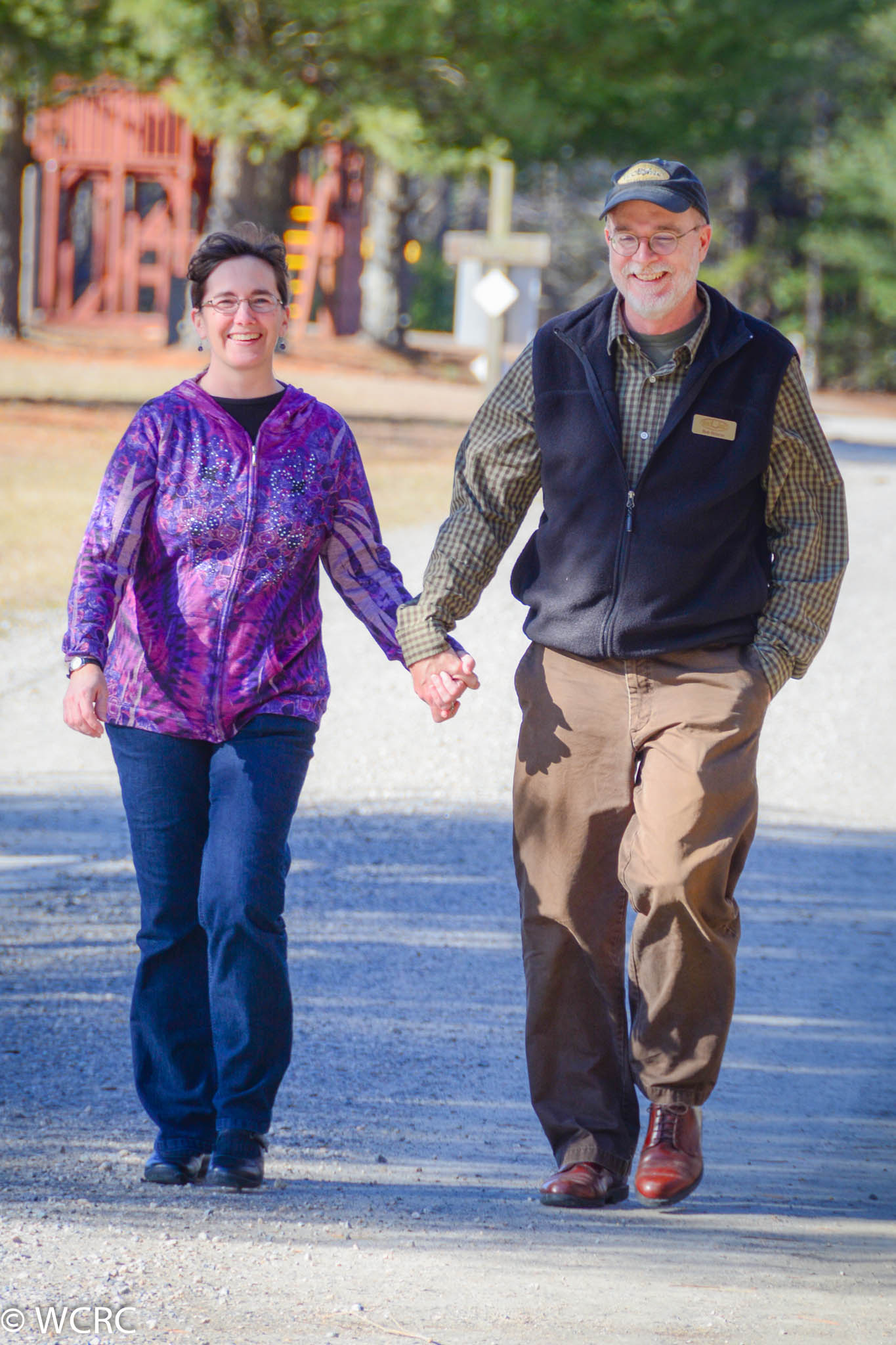 A Couple Walking On A Sunny Day At Williamsburg Christian Retreat Center In Virginia.