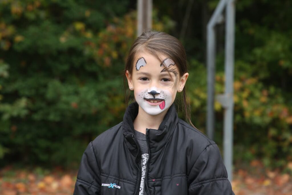 A Girl With Her Face Painted Like A Dog While At Wcrc'S Family Harvest Festival