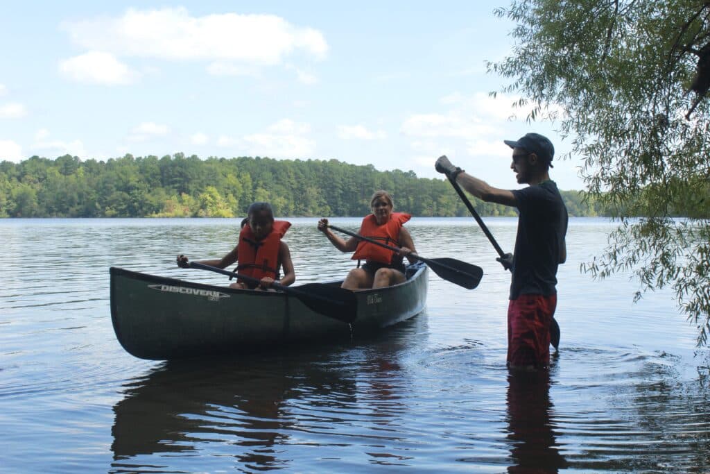 An Instructor From Wcrc Showing Campers How To Paddle With A Canoe Oar.