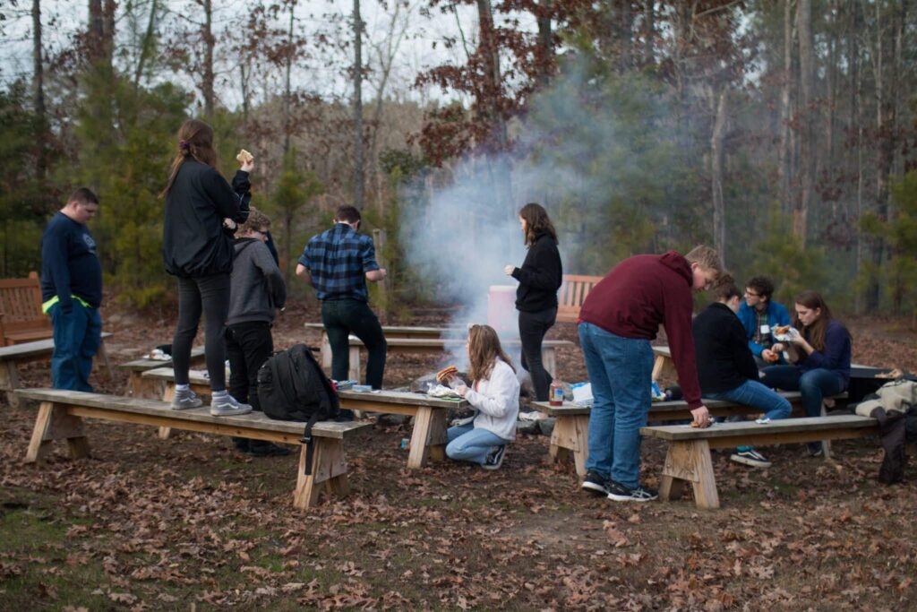 Winter Youth Retreat 2024 6 Teenagers Sitting Around A Campfire While Talking About Wcrc'S Winter Retreat In Williamsburg, Virginia
