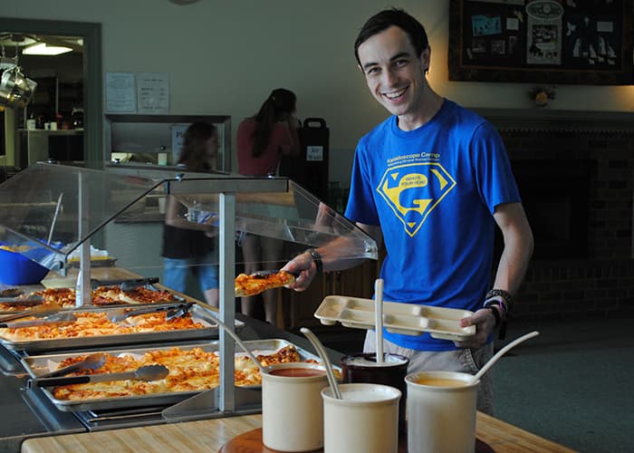 A Man Smiling While Serving Himself Food While At Wcrc In Williamsburg, Virginia